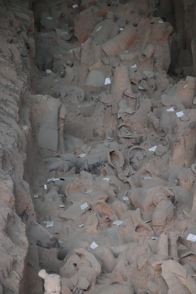Excavated terracotta fragments in their original burial context