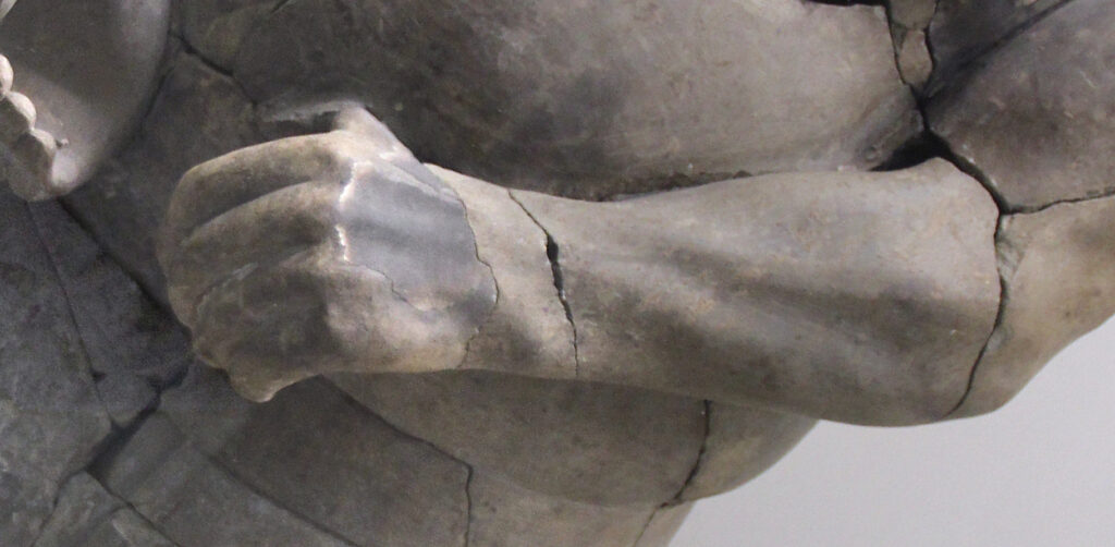 Close view of a terracotta strongman forearm and hand