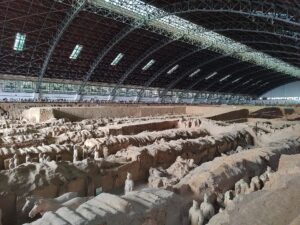 Wide view of Pit 1 showing earthen walls, parallel corridors, warriors, and the modern exhibition hall