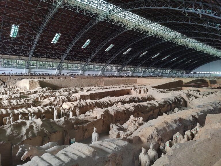 Wide view of Pit 1 showing earthen walls, parallel corridors, warriors, and the modern exhibition hall