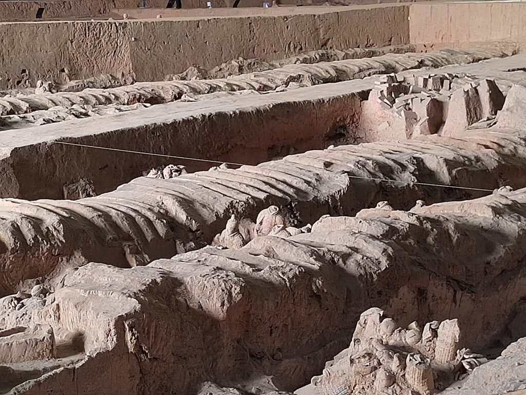 Close view of rammed-earth partitions and disturbed archaeological material in Pit 1