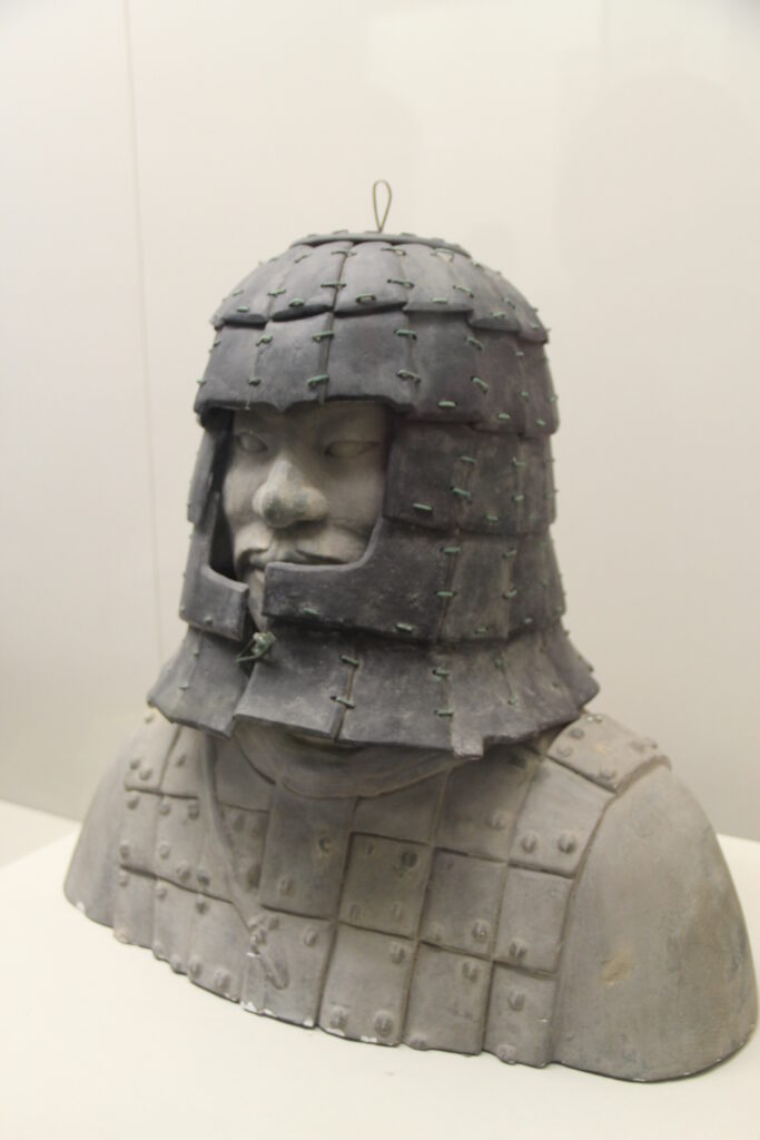 Stone helmet assembled on a museum display bust