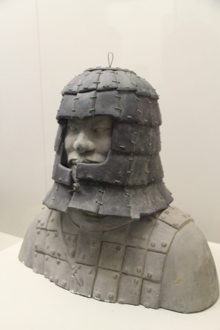 Stone helmet assembled on a museum display bust